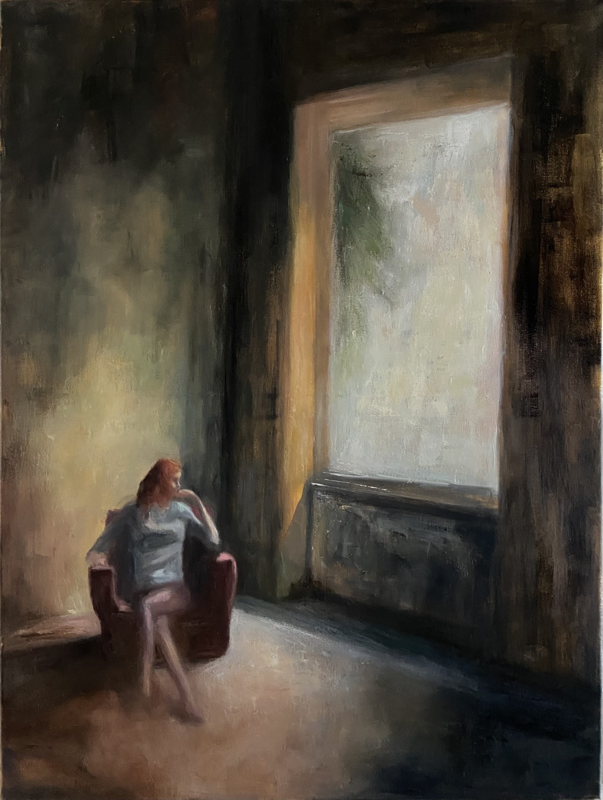 Picture of a woman in a big room looking outside the window